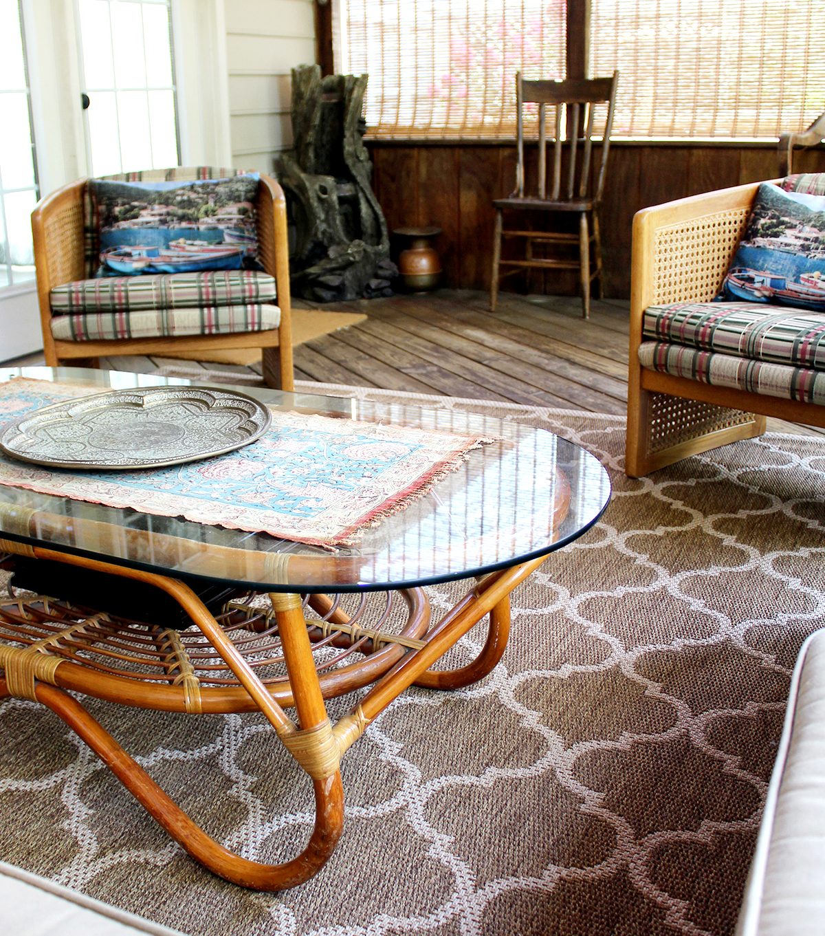 barrel chairs (thrift store find) with vintage coffee table on a screened porch
