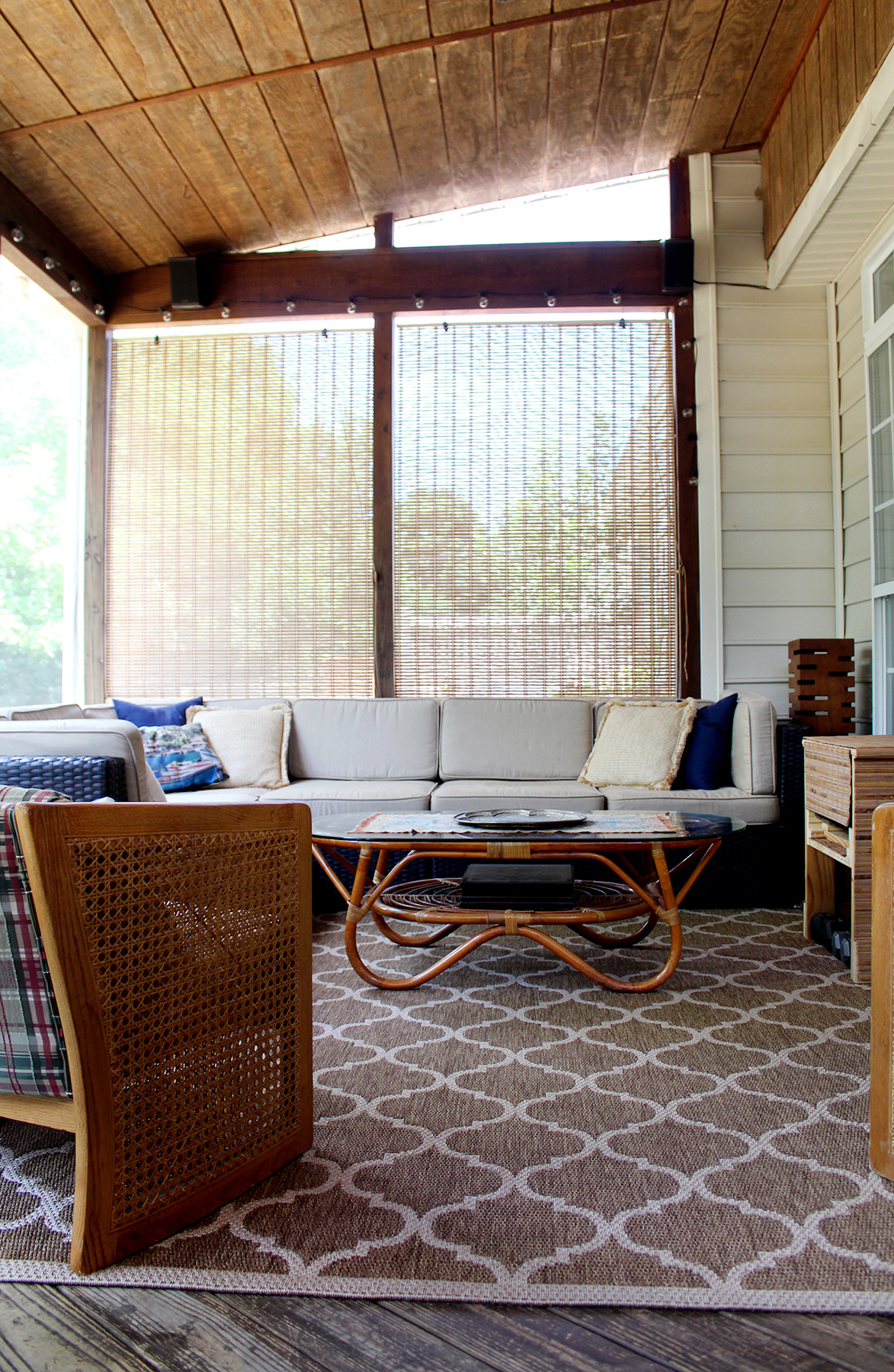 screened porch with sectional and vintage coffee table