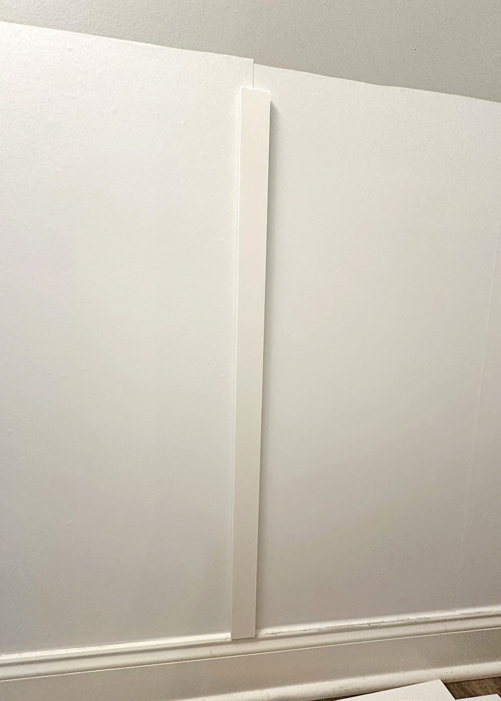 lowerstrip-1 | Tag and Tibby Attach pvc molding to the wall using hanging strips and a level | how to make faux board and batten