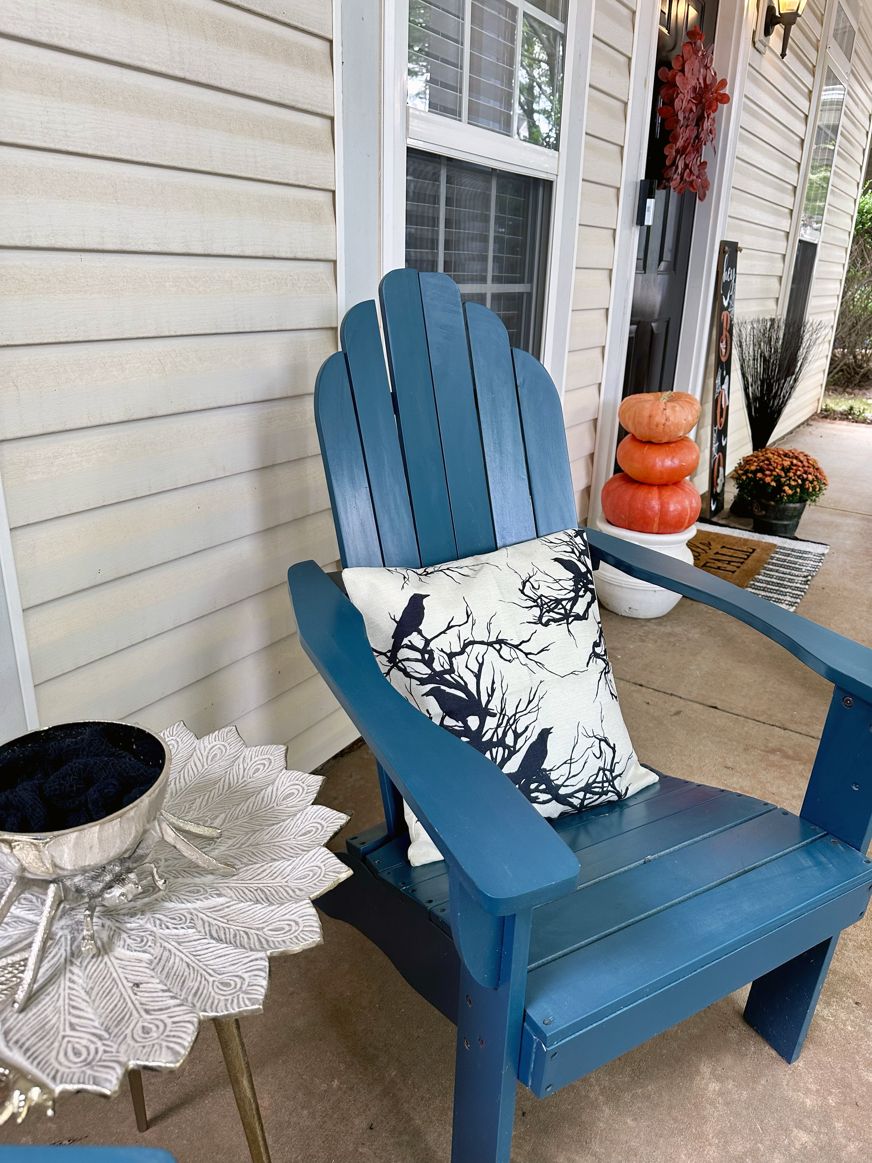 halloween front porch with spider bowl and spooky pillows